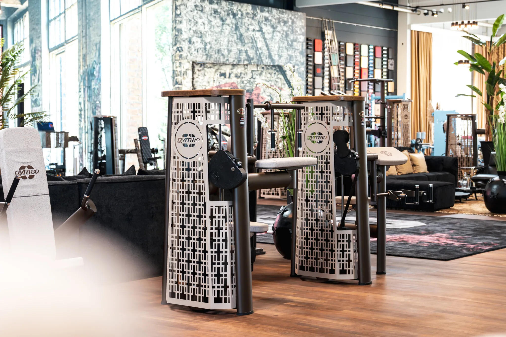 A gym80 training space with strength equipment and warm architectural finishes